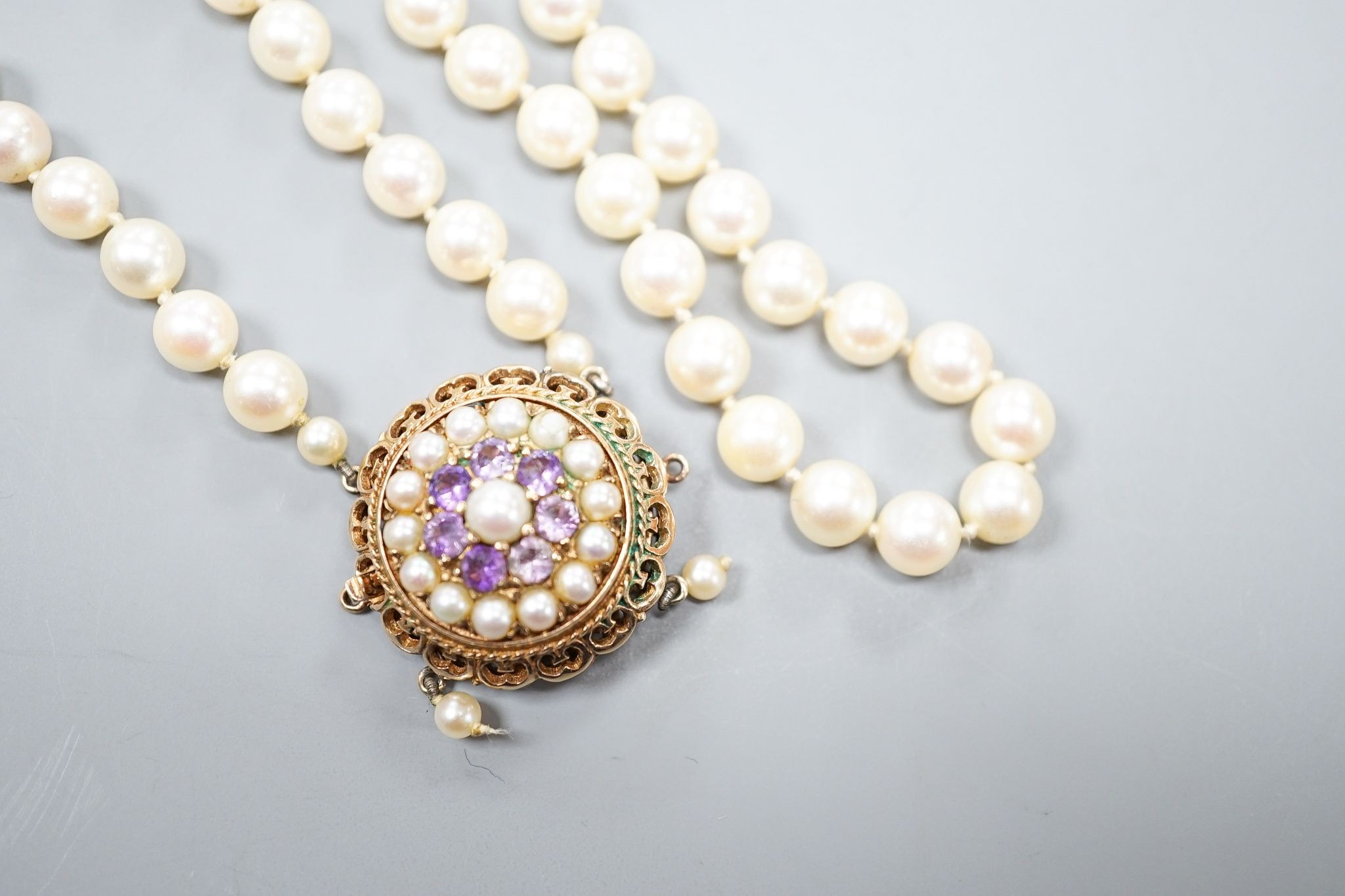 A 1960's double strand cultured pearl necklace, with 9ct gold, amethyst and cultured pearl set clasp (a.f.), approx. 40cm